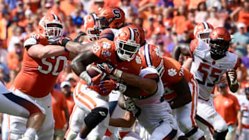 CLEMSON, SC - SEPTEMBER 29: Running back Tavien Feaster #28 of the Clemson Tigers pushes for yards after contact against the Syracuse Orange during the football game at Clemson Memorial Stadium on September 29, 2018 in Clemson, South Carolina. (Photo by Mike Comer/Getty Images)
