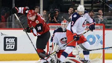 GLENDALE, AZ - JANUARY 25: Christian Dvorak #18 of the Arizona Coyotes tries to re-direct the puck in front of goalie Sergei Bobrovsky #72 of the Columbus Blue Jackets as Seth Jones #3 of the Blue Jackets defends during the third period at Gila River Arena on January 25, 2018 in Glendale, Arizona. (Photo by Norm Hall/NHLI via Getty Images)