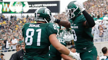 EAST LANSING, MI - OCTOBER 29: LJ Scott #3 of the Michigan State Spartans celebrates a first quarter touchdown with Matt Sokol #81 while playing the Michigan Wolverines at Spartan Stadium on October 29, 2016 in East Lansing, Michigan. (Photo by Gregory Shamus/Getty Images)