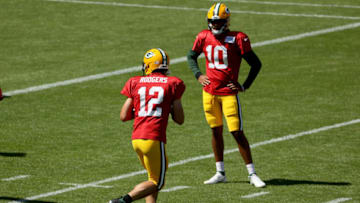 GREEN BAY, WISCONSIN - AUGUST 20: Aaron Rodgers #12 of the Green Bay Packers participates in a drill as Jordan Love #10 looks on during Green Bay Packers Training Camp at Lambeau Field on August 20, 2020 in Green Bay, Wisconsin. (Photo by Dylan Buell/Getty Images)
