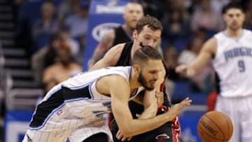 Feb 25, 2015; Orlando, FL, USA; Miami Heat guard Goran Dragic (7) fouls Orlando Magic guard Evan Fournier (10) during the second quarter at Amway Center. Mandatory Credit: Kim Klement-USA TODAY Sports