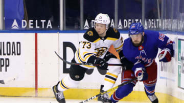 Feb 10, 2021; New York, New York, USA; Charlie McAvoy #73 of the Boston Bruins checks Ryan Lindgren #55 of the New York Rangers against the boards during the second period at Madison Square Garden. Mandatory Credit: Bruce Bennett/Pool Photo-USA TODAY Sports