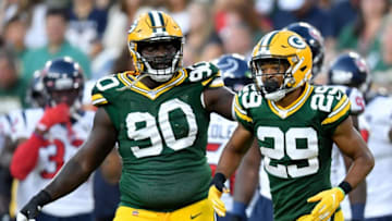 GREEN BAY, WISCONSIN - AUGUST 08: Montravius Adams #90 and Ka'dar Hollman #29 of the Green Bay Packers celebrate after Hollman made an interception in the first quarter against the Houston Texans during a preseason game at Lambeau Field on August 08, 2019 in Green Bay, Wisconsin. (Photo by Quinn Harris/Getty Images)
