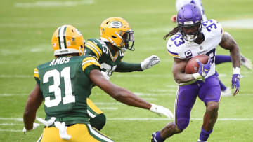 GREEN BAY, WISCONSIN - NOVEMBER 01: Dalvin Cook #33 of the Minnesota Vikings runs the ball as Aaron Jones #33 of the Green Bay Packers defends during the second quarter of the game at Lambeau Field on November 01, 2020 in Green Bay, Wisconsin. (Photo by Stacy Revere/Getty Images)