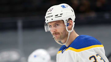 BOSTON, MA - APRIL 13: Colin Miller #33 of the Buffalo Sabres looks on against the Boston Bruins at TD Garden on April 13, 2021 in Boston, Massachusetts. (Photo by Adam Glanzman/Getty Images)