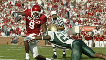 NORMAN, OK - NOVEMBER 15: Wide receiver Mark Clayton #9 of the Oklahoma Sooners tries to sidestep defensive back Matt Johnson #23 of the Baylor Bears November 15, 2003 at Memorial Stadium in Norman, Oklahoma. The Sooners won 41-3 to stay undefeated at 10-0. (Photo by Brian Bahr/Getty Images)