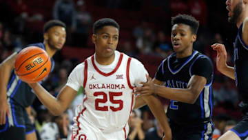 Oklahoma's Grant Sherfield (25) passes the ball as OCU's Avery Jackson defends during a college basketball exhibition game between the University of Oklahoma Sooners (OU) and the Oklahoma City University Starts (OCU) at Loyd Noble Center in Norman, Okla., Tuesday, Oct. 25, 2022.Ou Men S Basketball
