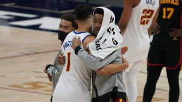 Mar 28, 2021; Denver, Colorado, USA; Atlanta Hawks forward John Collins (20) and Denver Nuggets forward Michael Porter Jr. (1) greet each other following the game at Ball Arena. Mandatory Credit: Ron Chenoy-USA TODAY Sports