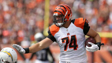 CINCINNATI, OH - SEPTEMBER 20: Jake Fisher #74 of the Cincinnati Bengals attempts to stiff-arm Eric Weddle #32 of the San Diego Chargers while carrying the ball during the third quarter at Paul Brown Stadium on September 20, 2015 in Cincinnati, Ohio. (Photo by Andy Lyons/Getty Images)