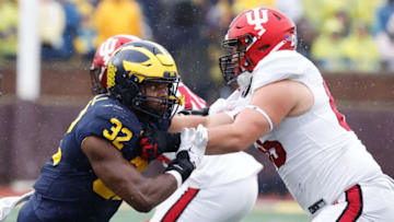 Oct 14, 2023; Ann Arbor, Michigan, USA; Michigan Wolverines defensive end Jaylen Harrell (32) rushes on defense at Indiana Hoosiers offensive lineman Carter Smith (65) in the second half at Michigan Stadium. Mandatory Credit: Rick Osentoski-USA TODAY Sports