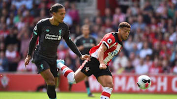 Southampton's English midfielder Che Adams (R) vies with Liverpool's Dutch defender Virgil van Dijk (L) during the English Premier League football match between Southampton and Liverpool at St Mary's Stadium in Southampton, southern England on August 17, 2019. (Photo by Glyn KIRK / AFP) / RESTRICTED TO EDITORIAL USE. No use with unauthorized audio, video, data, fixture lists, club/league logos or 'live' services. Online in-match use limited to 120 images. An additional 40 images may be used in extra time. No video emulation. Social media in-match use limited to 120 images. An additional 40 images may be used in extra time. No use in betting publications, games or single club/league/player publications. / (Photo credit should read GLYN KIRK/AFP via Getty Images)