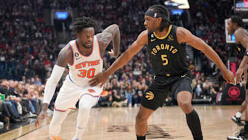 TORONTO, ON - JANUARY 6: Julius Randle #30 of the New York Knicks dribbles the ball against Precious Achiuwa #5 of the Toronto Raptors during the first half of their basketball game at the Scotiabank Arena on January 6, 2023 in Toronto, Ontario, Canada. NOTE TO USER: User expressly acknowledges and agrees that, by downloading and/or using this Photograph, user is consenting to the terms and conditions of the Getty Images License Agreement. (Photo by Mark Blinch/Getty Images)