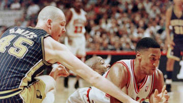 CHICAGO, UNITED STATES: Scottie Pippen (R) of the Chicago Bulls scrambles for a loose ball with Rik Smits (L) of the Indiana Pacers 27 May during the first half of game five of their NBA Eastern Conference finals game at the United Center in Chicago, Il. The series is tied at two game apiece. AFP PHOTO/Jeff HAYNES (Photo credit should read JEFF HAYNES/AFP via Getty Images)
