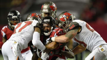 Nov 1, 2015; Atlanta, GA, USA; Tampa Bay Buccaneers cornerback Johnthan Banks (27) and strong safety Chris Conte (23) tackle Atlanta Falcons wide receiver Eric Weems (14) after a catch during the second half at the Georgia Dome. The Buccaneers defeated the Falcons 23-20 in over time. Mandatory Credit: Dale Zanine-USA TODAY Sports