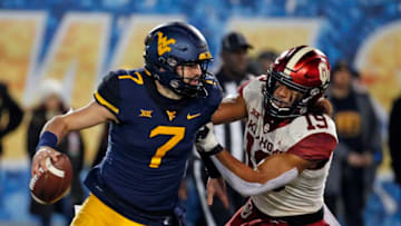 MORGANTOWN, WV - NOVEMBER 23: Caleb Kelly #19 of the Oklahoma Sooners forces Will Grier #7 of the West Virginia Mountaineers to fumble the football on November 23, 2018 at Mountaineer Field in Morgantown, West Virginia. (Photo by Justin K. Aller/Getty Images)