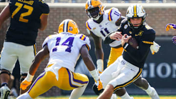 Oct 10, 2020; Columbia, Missouri, USA; Missouri Tigers quarterback Connor Bazelak (8) runs against LSU Tigers safety Maurice Hampton Jr. (14) during the first half at Faurot Field at Memorial Stadium. Mandatory Credit: Jay Biggerstaff-USA TODAY Sports