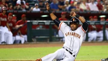 Sep 9, 2015; Phoenix, AZ, USA; San Francisco Giants base runner Alejandro De Aza slides into home to score on a wild pitch in the sixth inning against the Arizona Diamondbacks at Chase Field. Mandatory Credit: Mark J. Rebilas-USA TODAY Sports