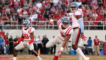 Oct 15, 2016; Fayetteville, AR, USA; Ole Miss Rebels defensive back A.J. Moore (30) linebacker DeMarquis Gates (3) and defensive tackle Breeland Speaks (9) celebrate after a sack by Gates in the first quarter against the Arkansas Razorbacks at Donald W. Reynolds Razorback Stadium. Mandatory Credit: Nelson Chenault-USA TODAY Sports