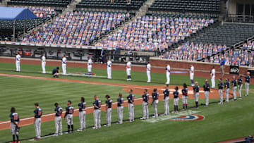 NEW YORK, NEW YORK - JULY 24: The New York Mets and the Atlanta Braves stand for the National Anthem during Opening Day at Citi Field on July 24, 2020 in New York City. Cardboard cutouts of fans are placed in the seats as no fans are allowed at the games due to the COVID-19 pandemic. The 2020 season had been postponed since March due to the COVID-19 pandemic. (Photo by Al Bello/Getty Images)