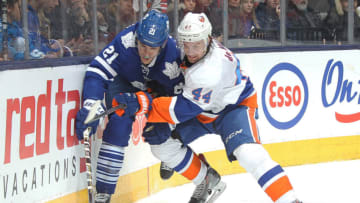 TORONTO, ON - MARCH 9: Calvin de Haan #44 of the New York Islanders squeezes James van Riemsdyk #21 of the Toronto Maple Leafs off the puck during an NHL game at the Air Canada Centre on March 9, 2015 in Toronto, Ontario, Canada. The Islanders defeated the Leafs 4-3 in overtime. (Photo by Claus Andersen/Getty Images)