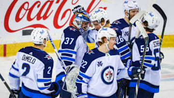 May 5, 2021; Calgary, Alberta, CAN; Winnipeg Jets goaltender Connor Hellebuyck (37) celebrate win with teammates against the Calgary Flames at Scotiabank Saddledome. Mandatory Credit: Sergei Belski-USA TODAY Sports