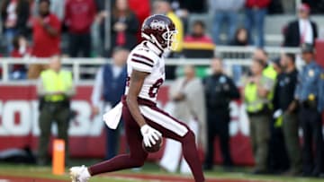 Auburn footballNov 6, 2021; Fayetteville, Arkansas, USA; Mississippi State Bulldogs wide receiver Rara Thomas (84) scores a touchdown against the Arkansas Razorbacks during the fourth quarter at Donald W. Reynolds Razorback Stadium. Arkansas won 31-28. Mandatory Credit: Nelson Chenault-USA TODAY Sports