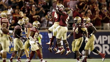 Sep 5, 2016; Orlando, FL, USA; Florida State Seminoles defensive back Tarvarus McFadden (4) celebrates with Florida State Seminoles linebacker Dontavious Jackson (5) after a interception in the fourth quarter at Camping World Stadium. Florida State Seminoles won 45-34. Mandatory Credit: Logan Bowles-USA TODAY Sports