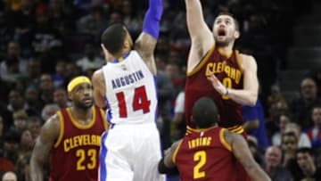 Jan 27, 2015; Auburn Hills, MI, USA; Detroit Pistons guard D.J. Augustin (14) attempts a shot over Cleveland Cavaliers forward Kevin Love (0) during the second quarter at The Palace of Auburn Hills. Mandatory Credit: Raj Mehta-USA TODAY Sports