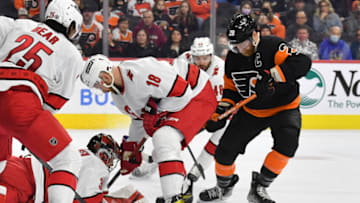 Feb 21, 2022; Philadelphia, Pennsylvania, USA; Carolina Hurricanes goaltender Frederik Andersen (31) and Carolina Hurricanes center Derek Stepan (18) battle for the puck with Philadelphia Flyers center Claude Giroux (28) during the second period at Wells Fargo Center. Mandatory Credit: Eric Hartline-USA TODAY Sports