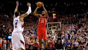 Apr 25, 2014; Portland, OR, USA; Houston Rockets guard Troy Daniels (30) makes a three point basket over Portland Trail Blazers forward LaMarcus Aldridge (12) with 12 seconds left in overtime to win game three of the first round of the 2014 NBA Playoffs at the Moda Center. Mandatory Credit: Craig Mitchelldyer-USA TODAY Sports