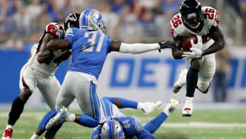 DETROIT, MI - SEPTEMBER 024: Tevin Coleman #26 of the Atlanta Falcons runs over D.J. Hayden #31 of the Detroit Lions and Jalen Reeves-Maybin #44 during the second quarter at Ford Field on September 24, 2017 in Detroit, Michigan. (Photo by Rey Del Rio/Getty Images)