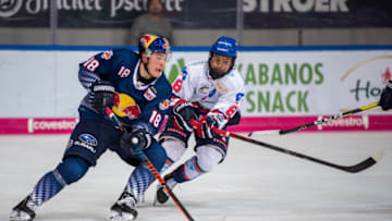 08 December 2019, Bavaria, Munich: Ice hockey: DEL, EHC Red Bull Munich - Adler Mannheim, main round, 25th matchday in the Olympic Ice Stadium Munich. Justin Schütz (l) from Red Bull Munich plays against Tim Stützle from Adler Mannheim at the Puck. Photo: Lino Mirgeler/dpa (Photo by Lino Mirgeler/picture alliance via Getty Images)