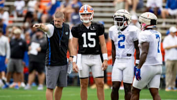 Florida Gators head coach Billy Napier gestures alongside Florida Gators quarterback Graham Mertz (15), Florida Gators running back Montrell Johnson Jr. (2), and Florida Gators running back Trevor Etienne (7) during fall football practice at Ben Hill Griffin Stadium at the University of Florida in Gainesville, FL on Saturday, August 5, 2023. [Matt Pendleton/Gainesville Sun]