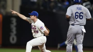 May 22, 2014; New York, NY, USA; New York Mets second baseman Daniel Murphy (28) gestures as he gets the force out on Los Angeles Dodgers right fielder Yasiel Puig (66) to end the top of the eighth inning at Citi Field. Mandatory Credit: Adam Hunger-USA TODAY Sports