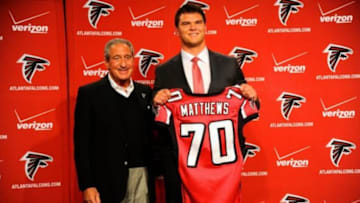 May 9, 2014; Atlanta, GA, USA; Atlanta Falcons team owner Arthur Blank and first round draft pick tackle Jake Matthews (with jersey) shown during a press conference at Falcons Training Facility. Mandatory Credit: Dale Zanine-USA TODAY Sports