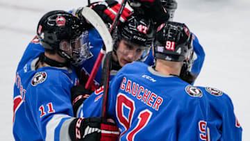 QUEBEC CITY, QC - NOVEMBER 4: Charle Truchon #47 of the Quebec Remparts is congratulated by his teammates James Malatesta #11 and Nathan Gaucher #91 after his goal against the Saint John Sea Dogs during their Quebec Major Junior Hockey League hockey game at the Videotron Center on November 4, 2021 in Quebec City, Quebec, Canada. (Photo by Mathieu Belanger/Getty Images)