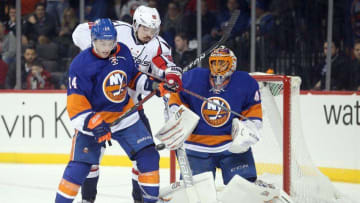 Dec 13, 2016; Brooklyn, NY, USA; New York Islanders defenseman Thomas Hickey (14) and Washington Capitals center Marcus Johansson (90) play the puck in front of New York Islanders goalie Jaroslav Halak (41) during the third period at Barclays Center. Mandatory Credit: Brad Penner-USA TODAY Sports