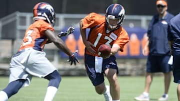 Jun 7, 2016; Englewood, CO, USA; Denver Broncos quarterback Trevor Siemian (13) prepares to hand off the ball during mini camp drills at the UCHealth Training Center. Mandatory Credit: Ron Chenoy-USA TODAY Sports