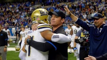 Jan 2, 2015; San Antonio, TX, USA; UCLA Bruins coach Jim Mora (right) and quarterback Brett Hundley embrace in the final minute against the Kansas State Wildcats in the 2015 Alamo Bowl at Alamodome. UCLA defeated Kansas State 40-35. Mandatory Credit: Kirby Lee-USA TODAY Sports