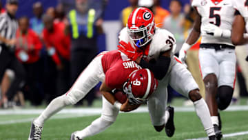 Bryce Young carries the ball as William Poole defends the play. (Photo by Kevin C. Cox/Getty Images)