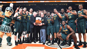 PORTLAND, OR - NOVEMBER 26: Nike co-founder Phil Knight presents head coach Tom Izzo of the Michigan State Spartans and the Michigan State Spartans the trophy for the 'Victory Bracket' Championship after the game during the PK80-Phil Knight Invitational presented by State Farm at the Moda Center on November 26, 2017 in Portland, Oregon. Michigan State won the game 63-45. (Photo by Steve Dykes/Getty Images)
