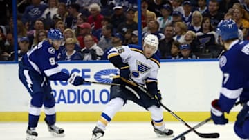 Feb 14, 2016; Tampa, FL, USA; St. Louis Blues center Paul Stastny (26) passes the puck as Tampa Bay Lightning center Steven Stamkos (91) defends during the third period at Amalie Arena. St. Louis defeated Tampa Bay 2-1. Mandatory Credit: Kim Klement-USA TODAY Sports