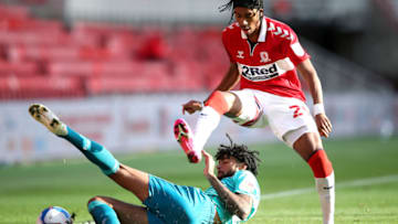 MIDDLESBROUGH, ENGLAND - SEPTEMBER 19: Djed Spence of Middlesbrough battles for possession with Philip Billing of AFC Bournemouth during the Sky Bet Championship match between Middlesbrough and AFC Bournemouth at Riverside Stadium on September 19, 2020 in Middlesbrough, England. Middlesbrough Football Club are allowing limited number of spectators (1000) to be in attendance as Covid-19 pandemic restrictions are eased. (Photo by Alex Pantling/Getty Images)