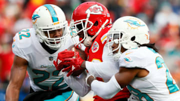 KANSAS CITY, MO - DECEMBER 24: Wide receiver Tyreek Hill #10 of the Kansas City Chiefs makes a catch as strong safety T.J. McDonald #22 and cornerback Bobby McCain #28 of the Miami Dolphins defend during the game at Arrowhead Stadium on December 24, 2017 in Kansas City, Missouri. (Photo by Jamie Squire/Getty Images)