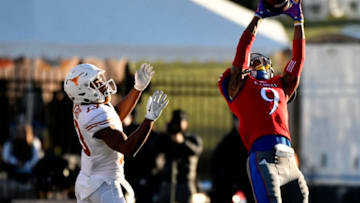 LAWRENCE, KS - NOVEMBER 19: Fish Smithson #9 of the Kansas Jayhawks intercepts a ball intended for wide receiver Jerrod Heard #13 of the Texas Longhorns in the second quarter at Memorial Stadium on November 19, 2016 in Lawrence, Kansas. (Photo by Ed Zurga/Getty Images)