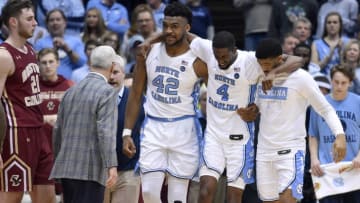 CHAPEL HILL, NORTH CAROLINA - FEBRUARY 01: Brandon Robinson #4 of the North Carolina Tar Heels is helped off the floor after being injured in the closing seconds during the second half of their game against the Boston College Eagles at the Dean Smith Center on February 01, 2020 in Chapel Hill, North Carolina. Boston College won 71-70. (Photo by Grant Halverson/Getty Images)