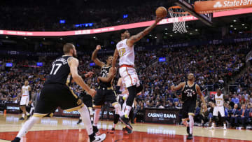 TORONTO, ON - MARCH 30: Mike Scott #32 of the Atlanta Hawks drives to the basket as Jonas Valanciunas #17 and DeMar DeRozan #10 of the Toronto Raptors defend during the second half of an NBA game at the Air Canada Centre on March 30, 2016 in Toronto, Ontario, Canada. (Photo by Vaughn Ridley/Getty Images)