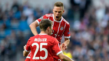 Bayern Munich's German midfielder Joshua Kimmich (back) celebrates with Bayern Munich's German forward Thomas Mueller after scoring a goal during the UEFA Champions League semi-final second leg football match between Real Madrid and Bayern Munich at the Santiago Bernabeu Stadium in Madrid on May 1, 2018. (Photo by OSCAR DEL POZO / AFP) (Photo credit should read OSCAR DEL POZO/AFP via Getty Images)