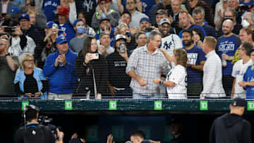 TORONTO, ON - SEPTEMBER 28: Roger Maris Jr. and Patty Judge share an embrace as Aaron Judge #99 of the New York Yankees celebrates in the dugout after hitting his 61st home run of the season in the first inning against the Toronto Blue Jays at Rogers Centre on September 28, 2022 in Toronto, Ontario, Canada. Judge has now tied Roger Maris for the American League record. (Photo by Cole Burston/Getty Images)