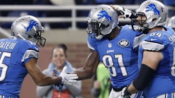 Oct 25, 2015; Detroit, MI, USA; Detroit Lions wide receiver Calvin Johnson (81) celebrates with center Travis Swanson (64) and wide receiver Golden Tate (15) after scoring a touchdown during the first quarter against the Minnesota Vikings at Ford Field. Mandatory Credit: Raj Mehta-USA TODAY Sports